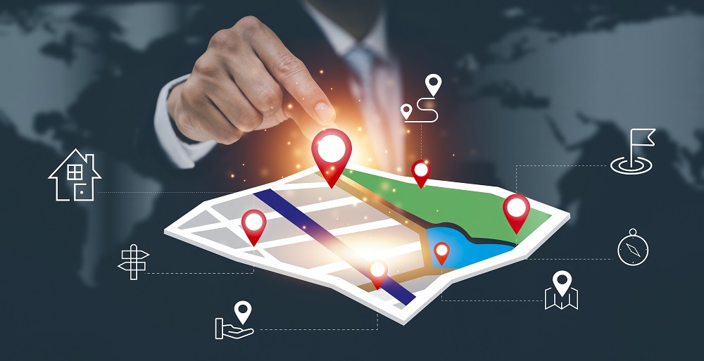 Businessman Hand Holding Virtual World Model Map With Location Point Gps App Icon Travel Maps Find Places Online System All Screen Graphics Are Generatedsearching Travel Goals